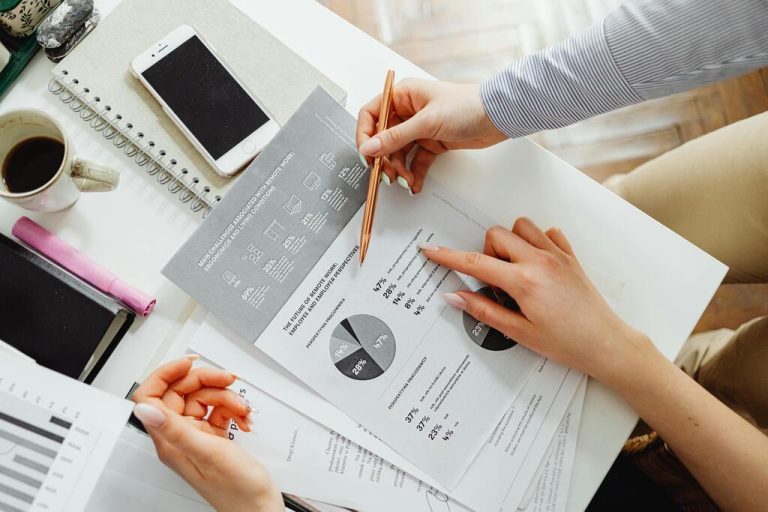team-collaborating-on-financial-documents-with-graphs-and-statistics-in-an-office-setting-5EVrVIp7pMxk68gvRLjrPg